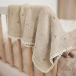Copertina neonato morbida beige nella culla
